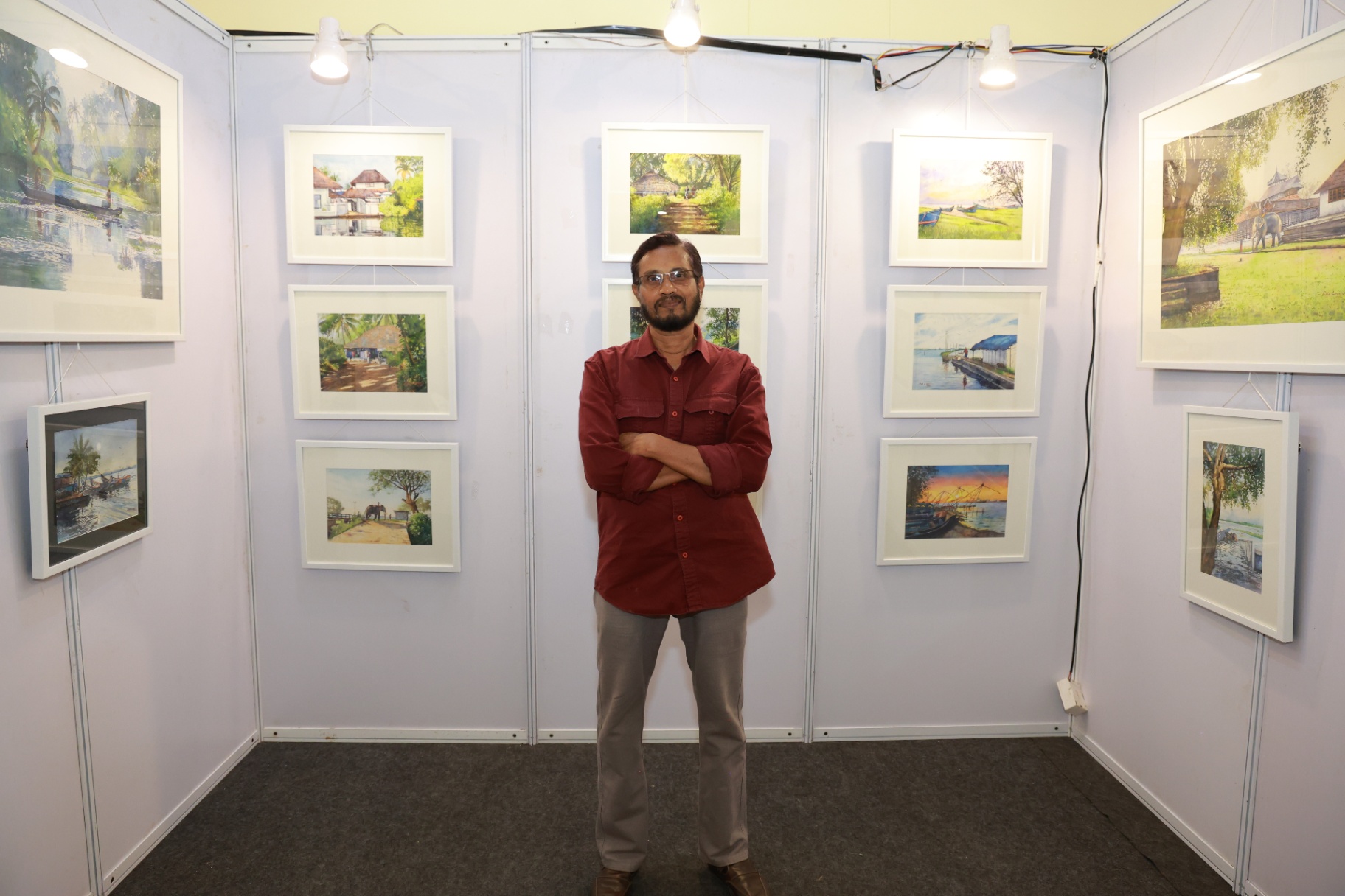 A painter beside his exhibited canvas